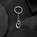 Stainless steel keychain with polished silver letter C pendant on dark rock texture - Letter C
