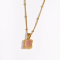 Detailed shot of a gold necklace with a pink stone pendant and hammered metal frame - Pink Gemstone (Style 3)