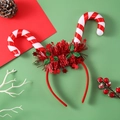 Detail of light-up Christmas headband featuring red candy canes and holly decorations - Candy Cane LED Headband