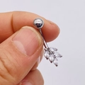 Macro shot of silver navel ring with leaf-shaped clear rhinestones on white background - Silver Four-Leaf Clover Style (JE0428L)