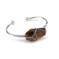 Detail of silver wire-wrapped hexagonal tiger eye stone on a handmade open cuff bracelet - Tiger Eye