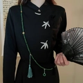 Detail of green beaded tassel pendant with jade charm on black embroidered cheongsam - Style 11 Necklace - Green Tassel