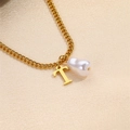 Elegant gold necklace featuring a Baroque pearl and initial T pendant on silk - Letter T Necklace