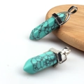 Turquoise hexagonal pillar pendants with silver bale on a minimalist wooden tray - Turquoise