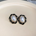 Detailed close-up of vintage gold earrings with white pearl and black enamel inlay - 2# Silver Earring Post Black Enamel Flower Pearl Oval Earrings