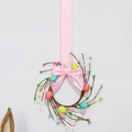 Detail view of Easter wreath with pastel eggs, small berries, and pink silk bow - 6 Easter Eggs Wreath with Pink Silk Bow