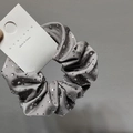 Macro shot of grey satin scrunchie with rhinestones on a white display card - Rhinestone Scrunchie / Gray Scrunchie