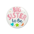 Close-up of white Big Sister to be badge with colorful moon and star patterns - Big sister to be