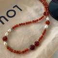 Beaded necklace with red agate, baroque pearls, and gold spacers on beige canvas - Southern Red Agate Necklace XL0386