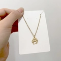 Detailed close-up of a gold-plated paw print pendant necklace with fine chain - DN112 Paw Print
