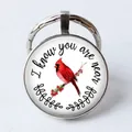 Silver keychain with glass dome featuring a cardinal bird and memorial quote design - Cardinal Bird/I know you are near