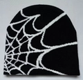 Close-up of black knitted beanie featuring white spider web jacquard texture and fine stitching - Black Base White Line