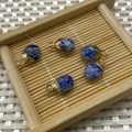 Five blue natural stone oval charms with gold clasps on a bamboo tray for DIY jewelry - Blue Spot Stone