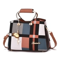 Orange and blue plaid handbag with golden circular handle and elegant pearl charm - Earthy Yellow