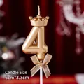 Golden number 4 birthday candle with a mini crown and mesh bow on a red background - Number Candles Crown Bow Champagne Color 4