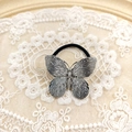 Silver alloy butterfly hair tie with black elastic band on elegant lace background - Silver Butterfly