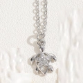 Silver sea turtle pendant necklace with sparkling zircon flowers on a fine link chain - Hollow Flower Turtle Style / Silver