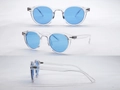 Detailansicht der runden Sonnenbrille mit blauen Gläsern und transparentem Kunststoffrahmen - Transparenter Rahmen Blaue Gläser