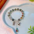 Lucky Maneki Neko bracelet with colorful crystal beads and retro silver charms in a dish - Phantom Colored Transparent Crystal Fortune Cat Bracelet