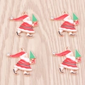 Gold Santa Claus charms with green tree and rhinestone on wooden background - Red