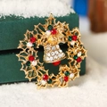 Christmas wreath brooch with bells and colorful rhinestones on a green gift box - Snowflake Bell