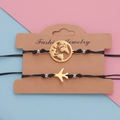 Set de pulseras de cuerda negra con dijes de avión y globo terráqueo dorados - Conjunto de Avión y Mapa / Dorado