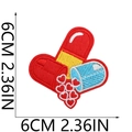 Detail of red capsule patch with embroidered hearts showing fine stitching and 6cm size - No.8 Heart Pill