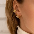 Detail of a woman wearing gold twisted hoop earrings and an ear cuff set in stainless steel - Gold (TZ00361)