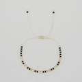 Handmade beaded bracelet with faceted black stones and gold metal spacers on adjustable cord - Black