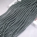 Macro shot of dark grey metallic pearls with high luster on a stylish brand display box - 5mm (Approx. 180pcs/Strand) / Tahitian Black Pearl