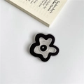 Transparent flower-shaped phone socket in black and clear design on white desk - Black