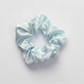 Light blue satin hair scrunchie with silky shine on white textured background - Scrunchie_Silky Blue