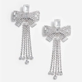 Elegant silver bow earrings with long rhinestone tassels on a clean white background - Bow Tassel Ear Clip / Silver