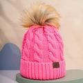 Close-up of rose pink cable knit beanie featuring thick texture and fluffy pompom detail - One Size / Rose Pink