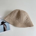 Detail shot of beige cable-knit bucket hat featuring thick cotton texture and ribbed brim - Khaki