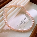 Detail view of pink pearl necklace in velvet box featuring S925 silver tag and soft lighting - 10mm Pink Single Strand (69#) / Pink