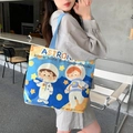 Blue and yellow canvas tote bag featuring a cute astronaut print for daily use - Space Boy