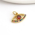 Macro shot of evil eye pendant with gold finish and vibrant multi-color zircon stones - Red Zirconia Eye