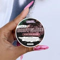 Hand holding Hllozzi Body Glaze jar for smooth and shiny skin with donut scent - Scent From Heaven / Small