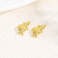 Macro shot of two golden turtle pendants with shell texture for DIY jewelry making - Sea Turtle / Gold