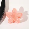 Detail of a glossy pink flower hair claw clip with gradient petals and gold metal spring - Jelly Dark Orange
