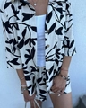 Detail of black and white leaf print fabric and wood buttons on cotton linen set - S / Black