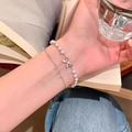 Detail of double-layer pearl bracelet with silver bow pendant on a female wrist - Double Layer Bowknot Pearl Bracelet