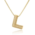 Macro shot of gold-plated letter L pendant with pavé cubic zirconia on a box chain - Letter L