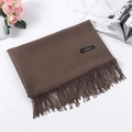 Solid brown cashmere feel scarf with fringe detail and black brand label on white surface - Coffee