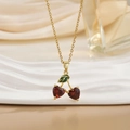 Golden titanium steel necklace featuring cherry heart pendants on white textured tray - Red Heart Zirconia Cherry Style (XL0576)