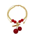 Detail of adjustable beaded cherry bracelet with gold beads and red fruit pendant - Green Leaf Cherry Pendant (C)