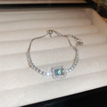 Macro shot of silver-tone bracelet featuring rectangular sea blue zircon and adjustable clasp - 18# Bracelet-Silver & Blue-Sea Blue Baguette Style