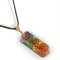 Macro view of Orgone pendant with natural seven chakra stones and copper coil spiral - Resin Gravel Pendant + Leather Cord