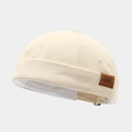 Detail of off-white canvas docker hat featuring brown leather DAD patch and neat stitching - Adjustable / DAD Patch Beige